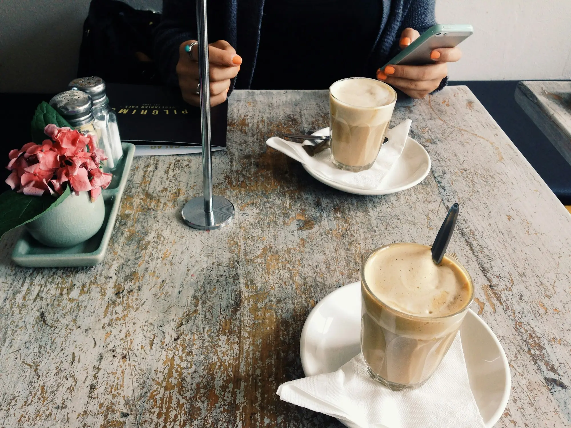 Coffee on an outdoor café table on a sunny afternoon