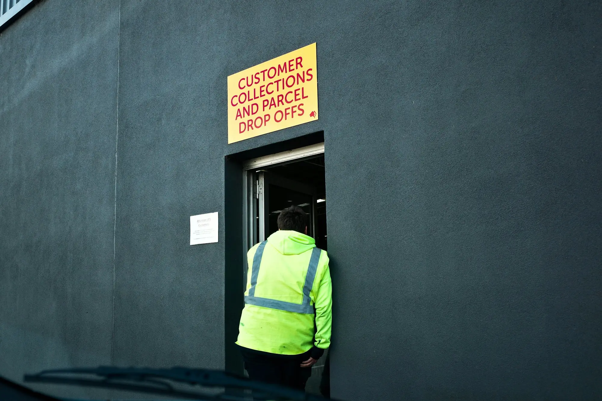Worker in hi-vis at a warehouse loading door